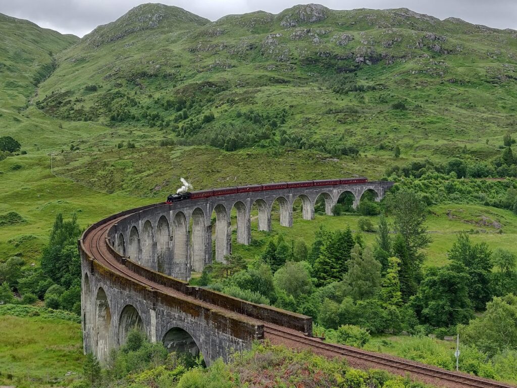 How to see the Hogwarts Express cross the Harry Potter Railway Bridge? This is the view of Glenfinnan Bridge from what is known as the Glenfinnan Viaduct Viewpoint