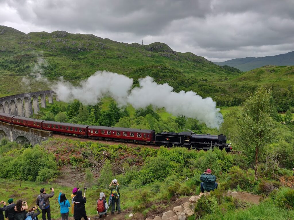 Watching the Hogwarts Express crossing the Harry Potter Railway Bridge from the Glenfinnan Viaduct Viewpoint