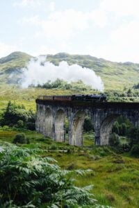 The view of the Hogwarts Express crossing the Harry Potter Railway bridge (aka from the Glenfinnan Viaduct Viewpoint)