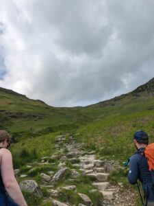 Hiking Helvellyn via Striding Edge - heading up the hillside at the start of the walk along the stone pathway